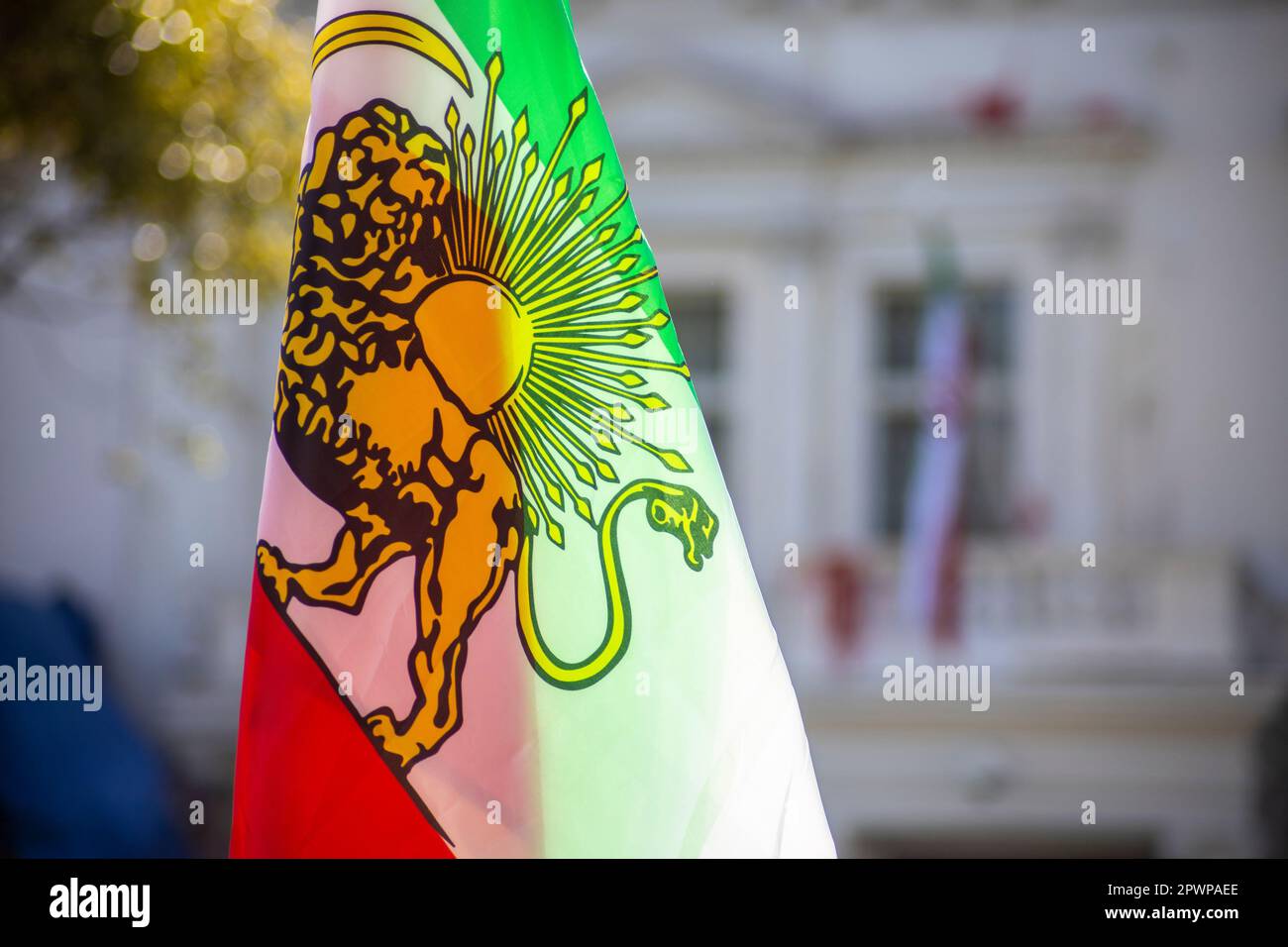 The Shir-o-Khorshid' (Lion and Sun) Flag of Iran is raised in front of Islamic Republic of Iran's Embassy in London. Stock Photo