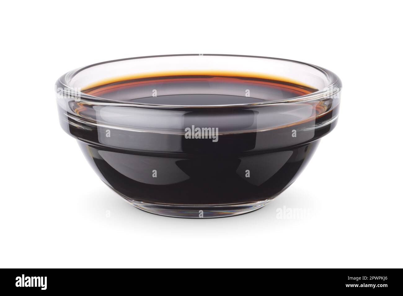 Glass dip bowl with soy sauce isolated on white background. Clipping