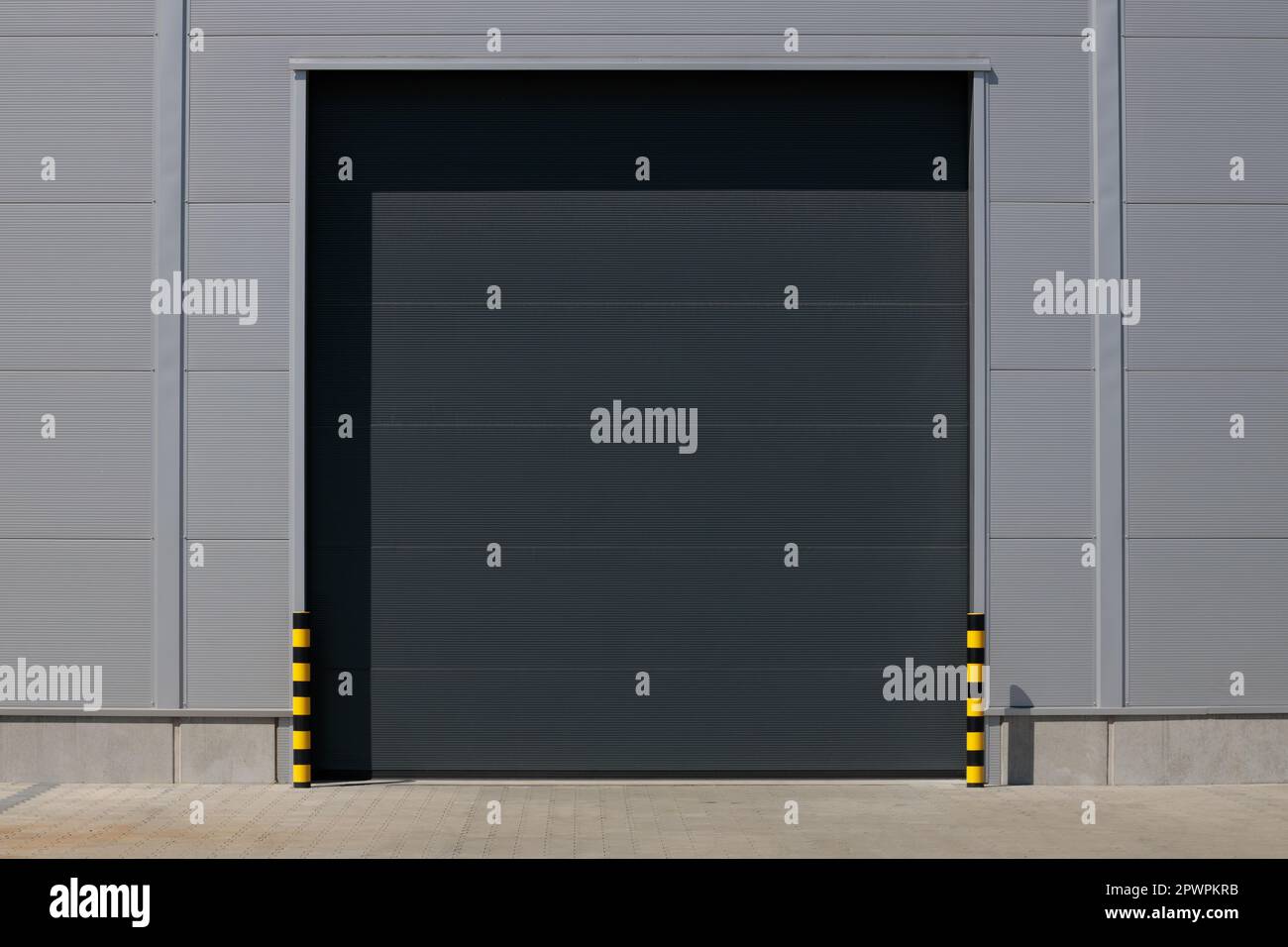 Loading dock entrance with rollup door in industrial building Stock