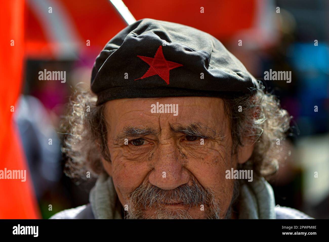 A man wearing a beret decorated with a traditional communist red star takes  part in a May Day rally, in Pamplona, northern Spain, Monday, May 1, 2023.  (AP Photo/Alvaro Barrientos Stock Photo -