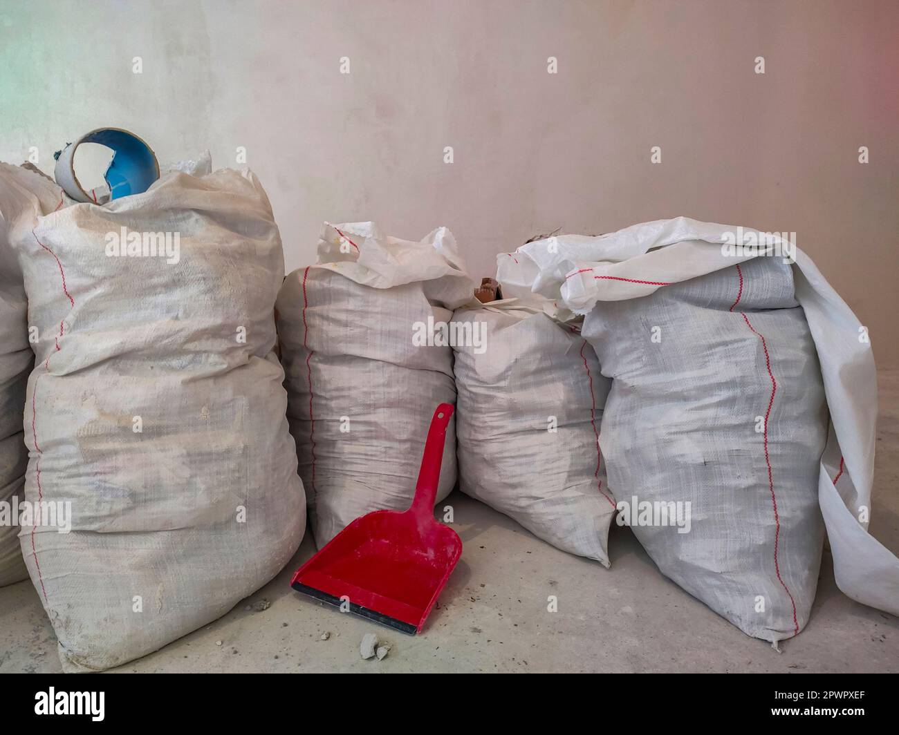 White polypropylene construction bags and scoop for garbage collection