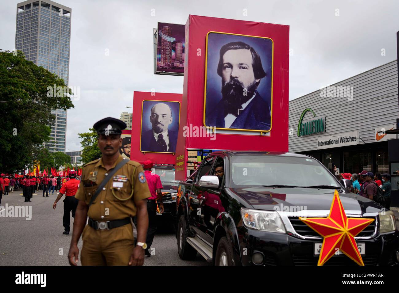 A Sri Lankan police officer stands guard as portraits of Communist ...