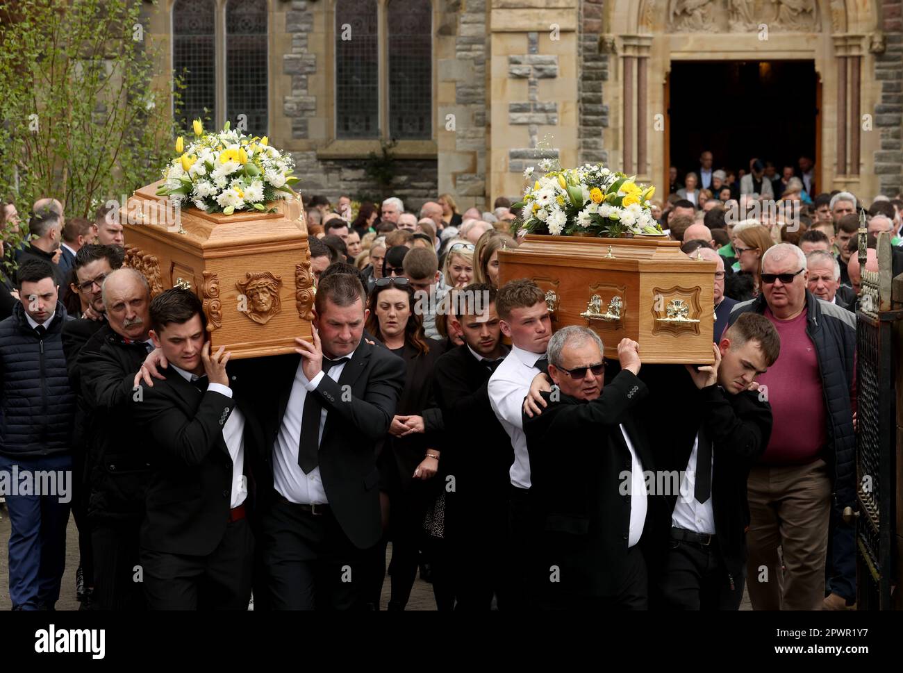 The coffins of Dan and Christine McKane, two of the three victims of ...