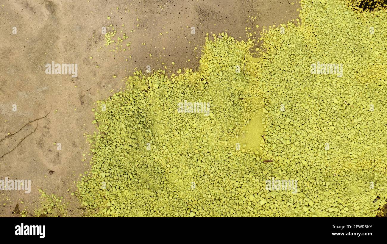 Chemical toxic waste from factory industry. Yellow sulphur powder. Hazardous waste. Acid toxic waste in factory concept. Toxic waste pollution. Soil c Stock Photo