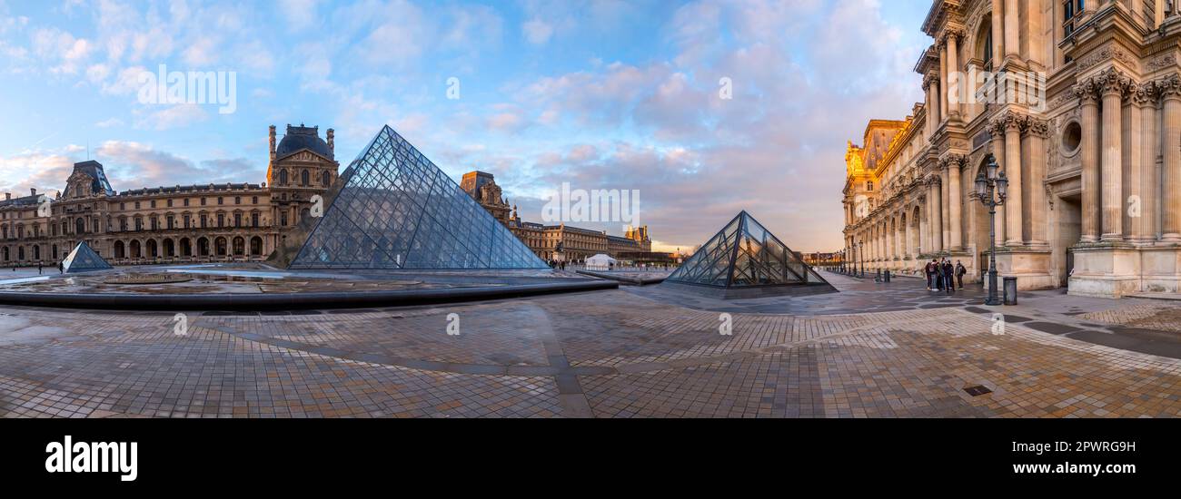Paris, France - JAN 24, 2022: The glass pyramid of Louvre Museum, the main entrance to famous museum and gallery, completed in 1989. Stock Photo