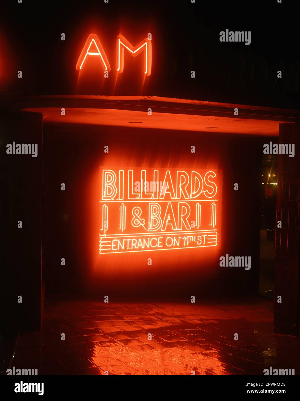 Amsterdam Billiards neon sign on a rainy night, in the East Village