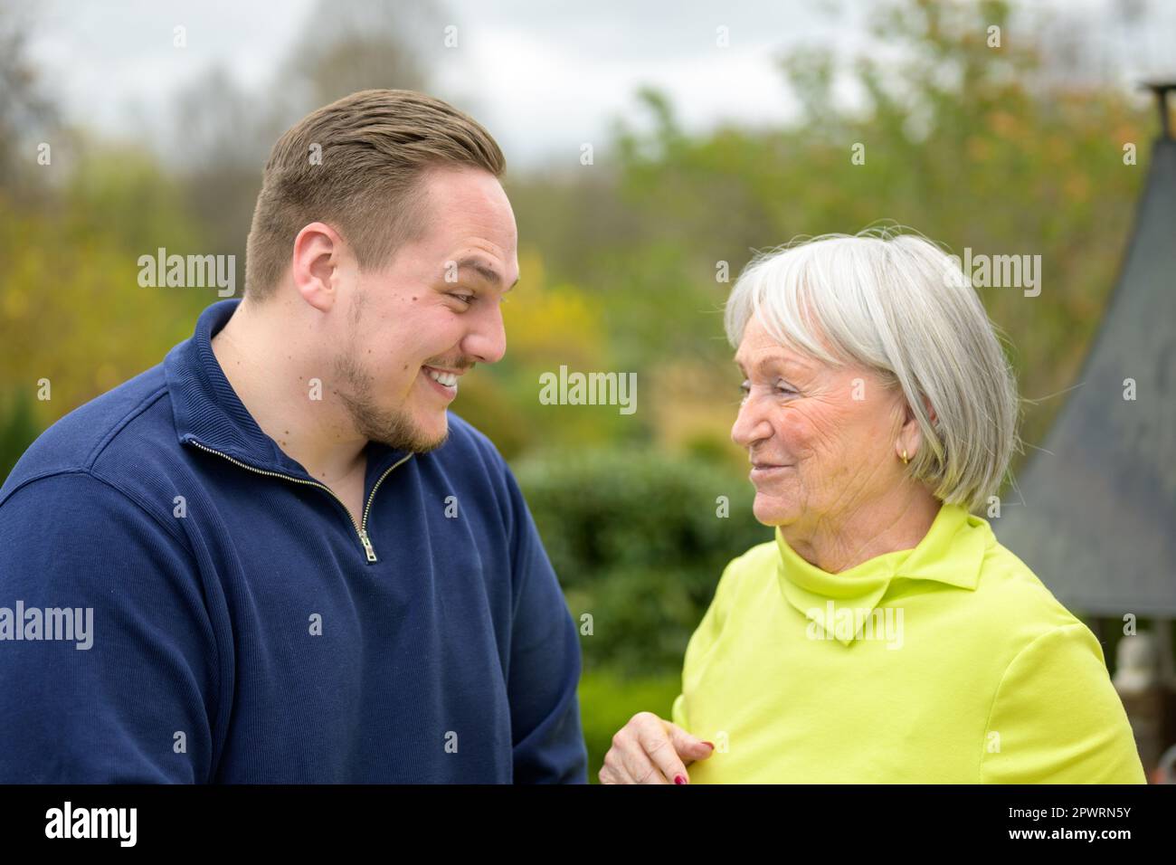 Two generation family, grandmother and grandson looking to each other laughing Stock Photo