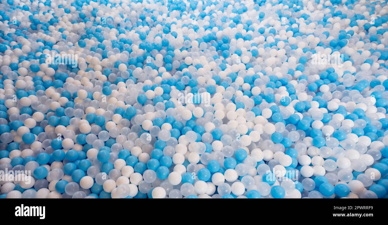Blue and white plastic balls in ball pool at kids playground. Colorful