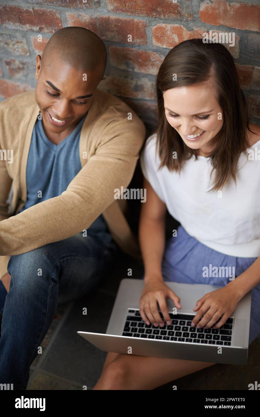 Working on their project after class. two students working on an assignment together. Stock Photo