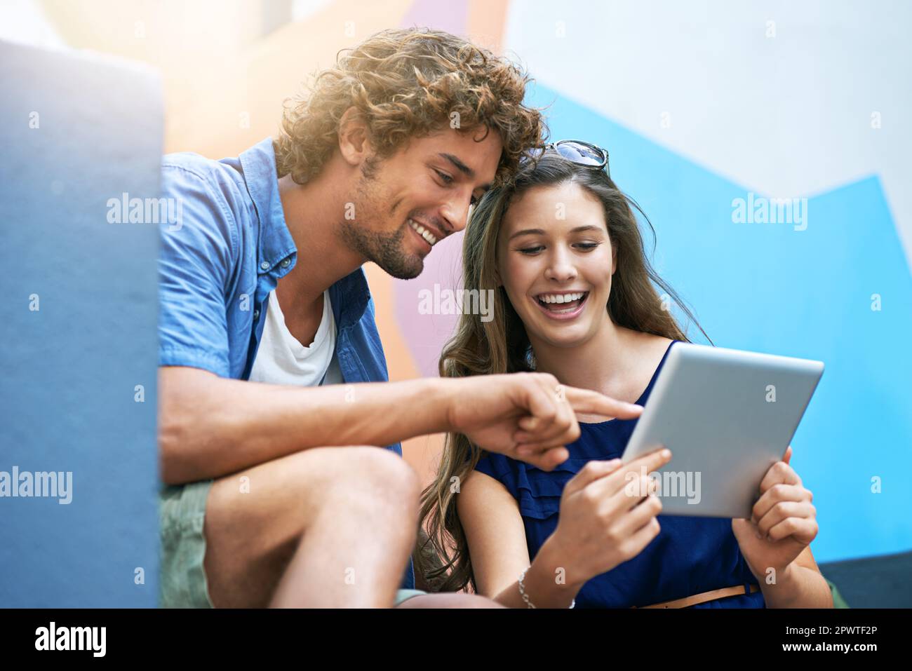 Check that out. two students using a tablet on campus. Stock Photo