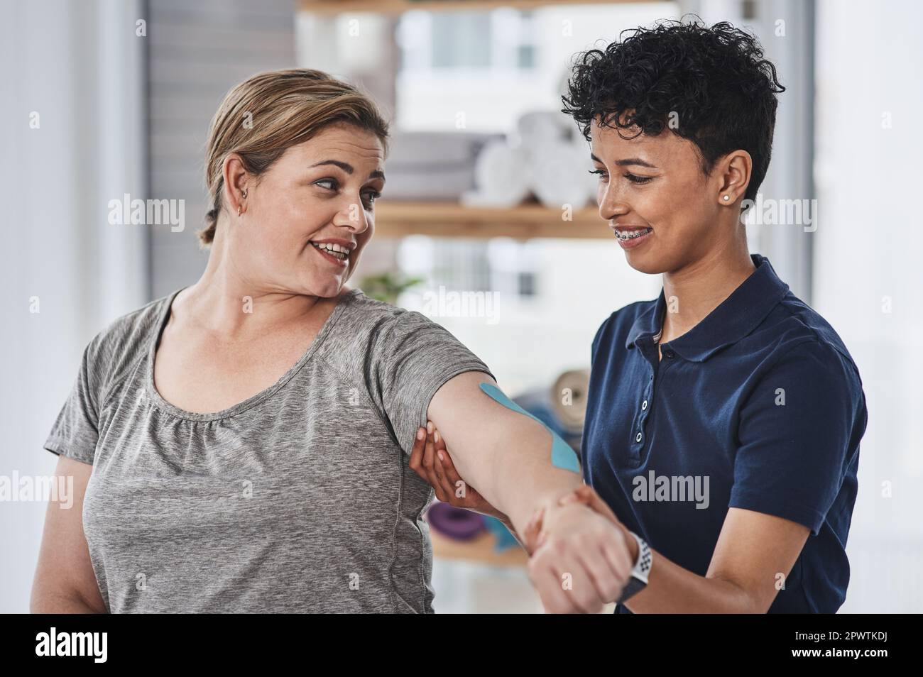 This helps strengthen weak muscles but also allows full mobility. a young physiotherapist