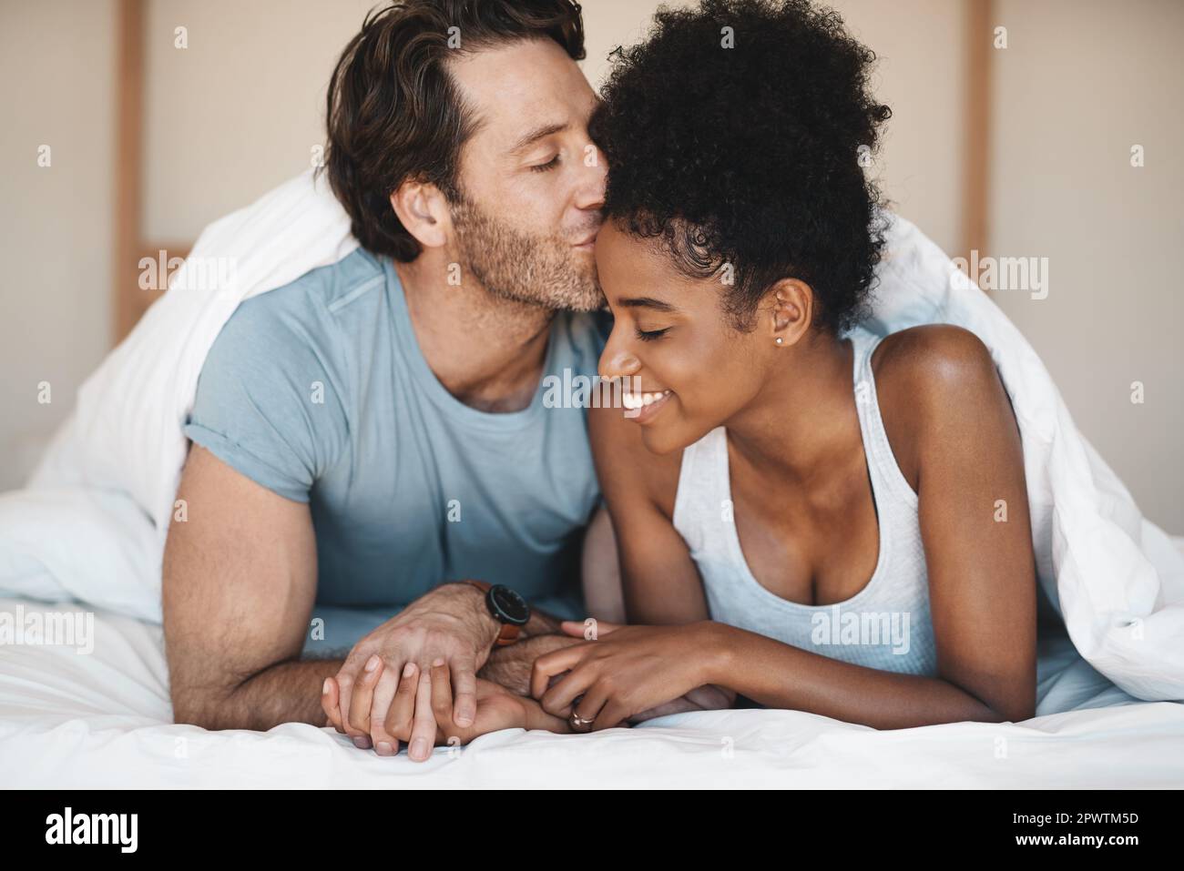 I just want to spend the day with my wife. an affectionate young couple  sharing an intimate moment in their bedroom at home Stock Photo - Alamy