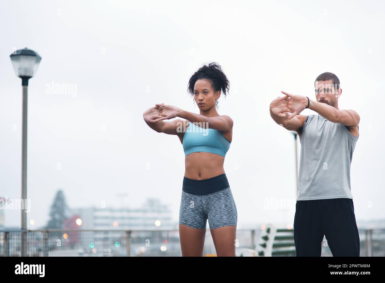 Stretch as far as you can to your goals. two sporty young people