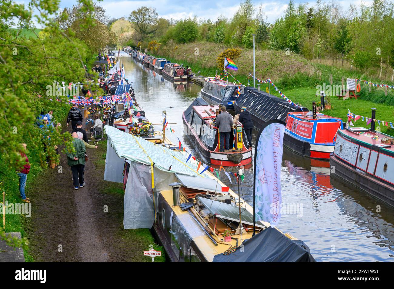 Boat traders selling gifts and other items from narrowboats attending the Norbury Canal Festival on the Shropshire Union Canal in Staffordshire. Stock Photo
