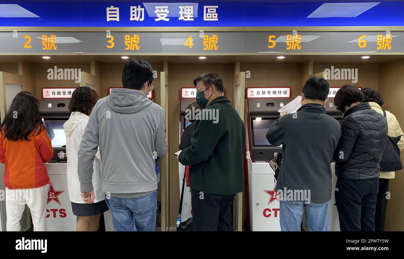 People apply for Home Return Permit at Hong Kong Island Service Centre of China Travel Service Hong Kong Ltd (CTS) in Sheung Wan. 29DEC22   SCMP / Jelly Tse Stock Photo