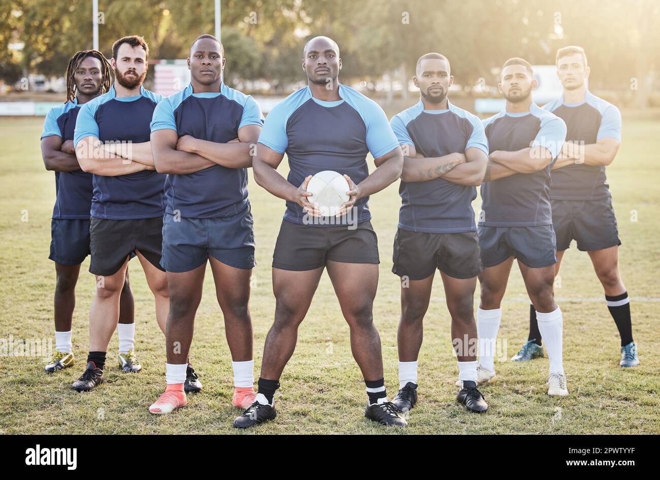 Portrait diverse young rugby players holding a rugby ball while ...