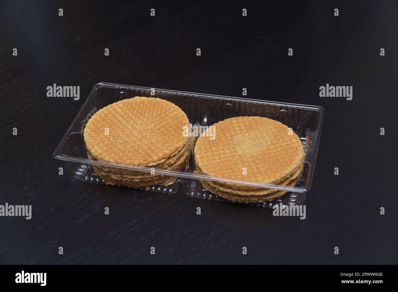 Delicious cookies in plastic packaging on a dark background Stock Photo