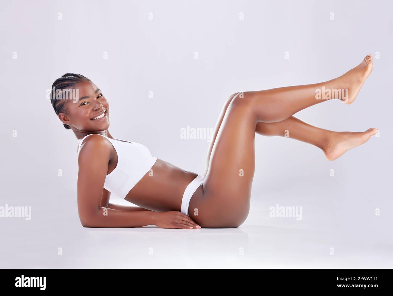 A Young Woman Lying on the Floor in the Studio Showing Her Big Long Legs  and Bottom, on a White Background. Copy Space Stock Photo - Image of legs,  fitness: 181216346