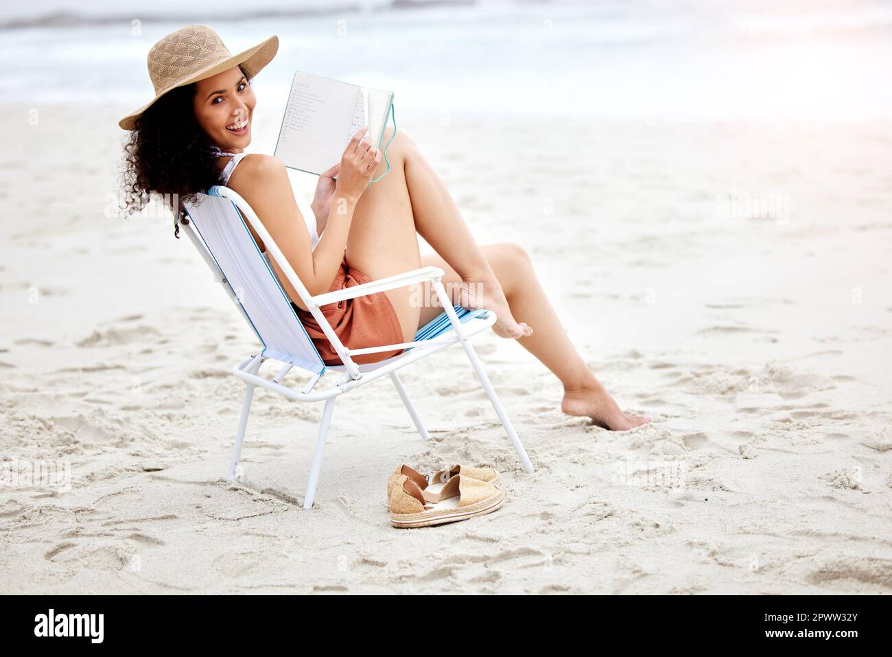 Young Model Girl Without Bra Relaxing With A Book On A Beach Near