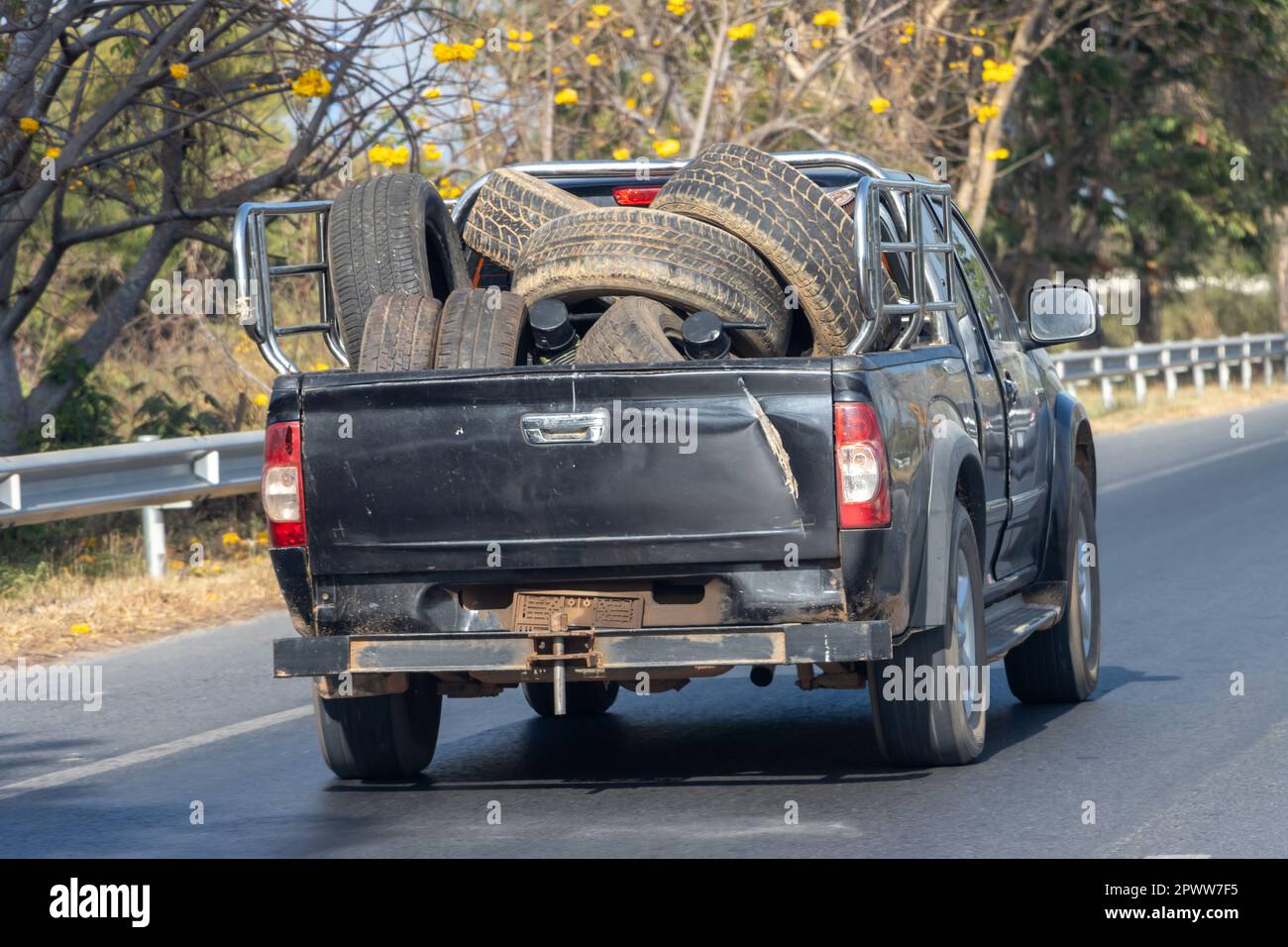 Transporting old tires on a pickup truck, Thailand Stock Photo