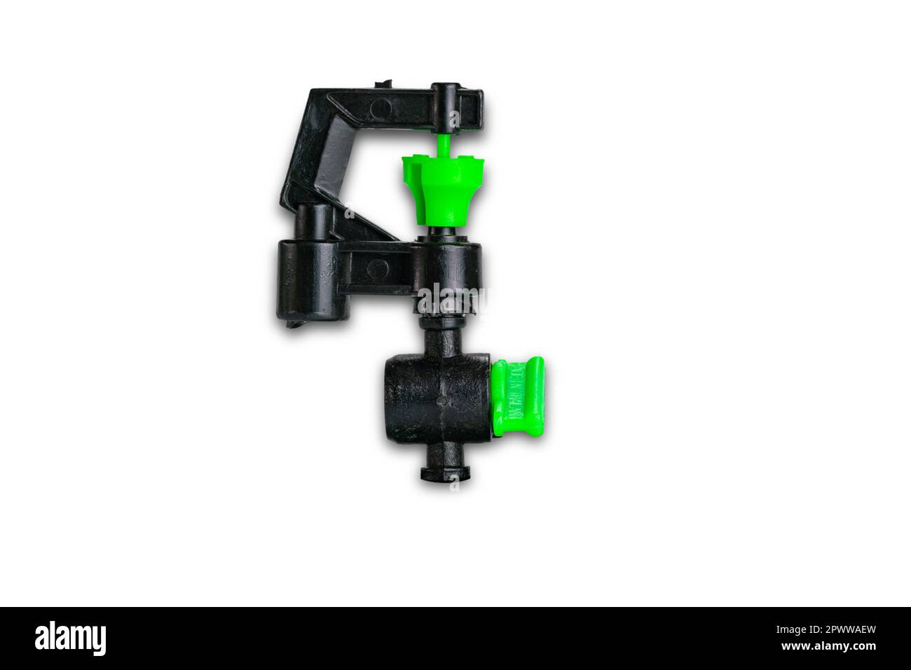 Small black and green plastic water sprinkler isolated on white background with clipping path, closeup, top view, horizontal format. Stock Photo