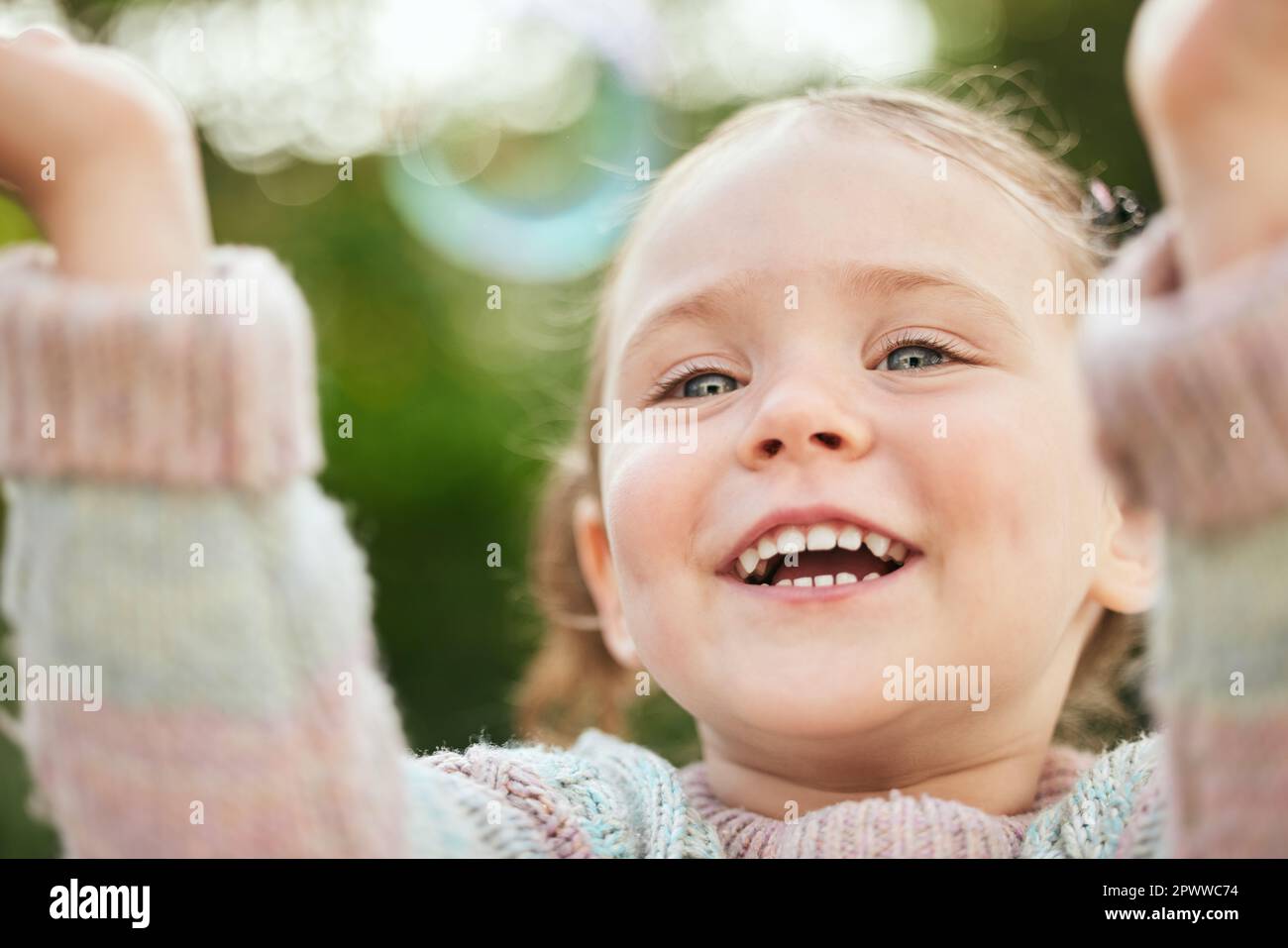 It doesnt take much to entertain a child. an adorable little girl playing outside Stock Photo