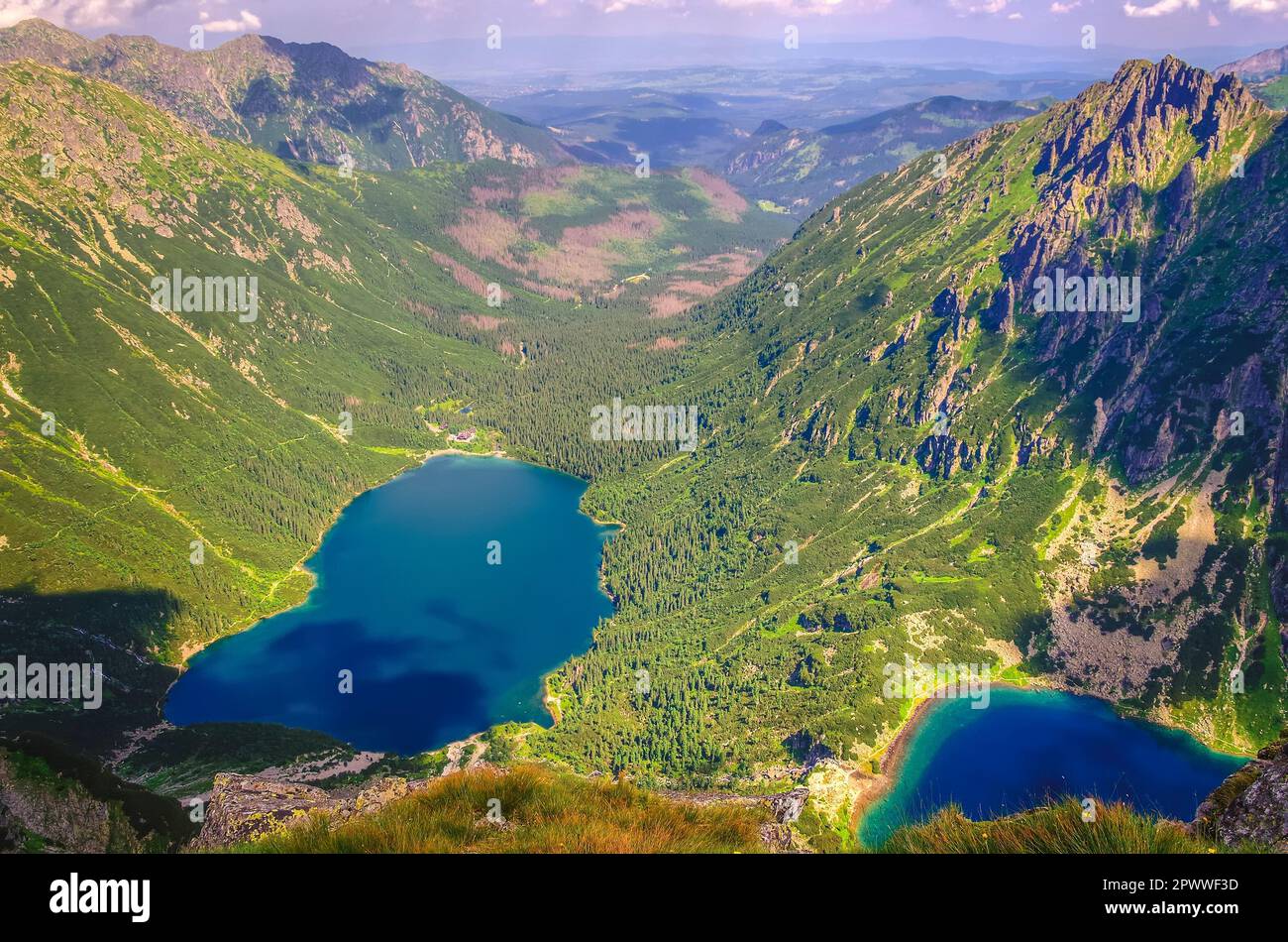 Two lakes in summer mountains. Two blue mountain lakes surrounded by high summits. Eye of the Sea (Morskie Oko) and Black Pond (Czarny Staw) are the m Stock Photo