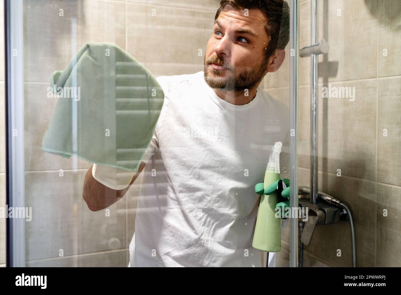 Man cleaning and wiping glass wall in shower room Stock Photo Alamy