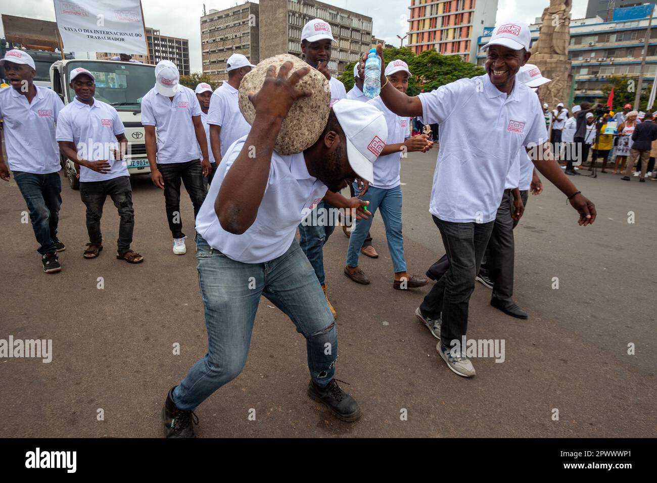 Maputo, Mozambique - May 01, 2023: Protesting the heavy weight of work, a worker's May Day demonstration with a stone on his shoulder Stock Photo