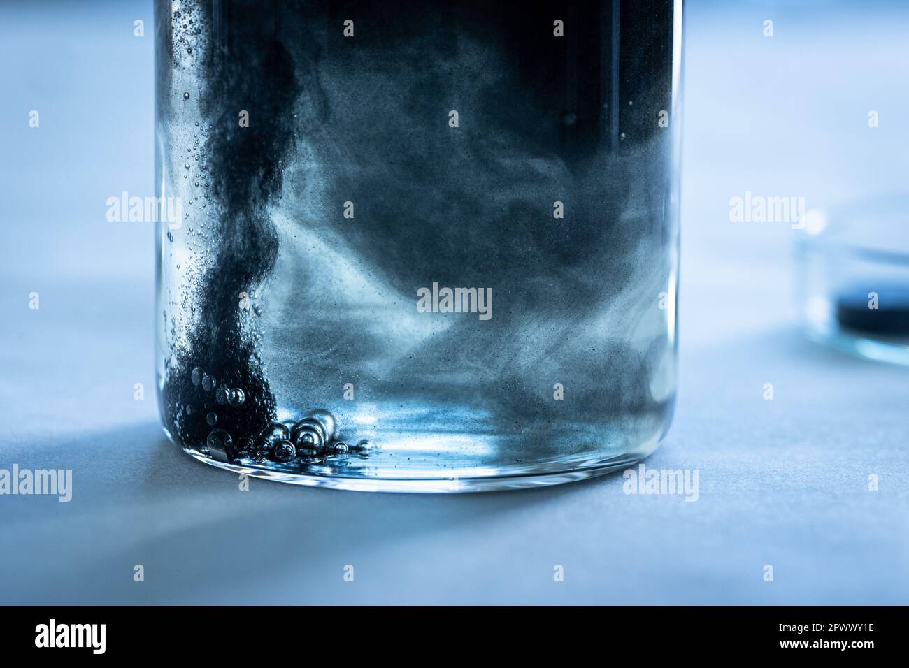 Iron nanoparticles in a lab, on a white glossy surface Stock Photo