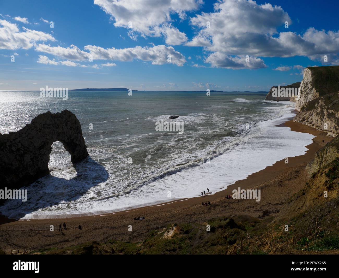 Durdle door and beach on a sunny day in March, Dorset, UK Stock Photo
