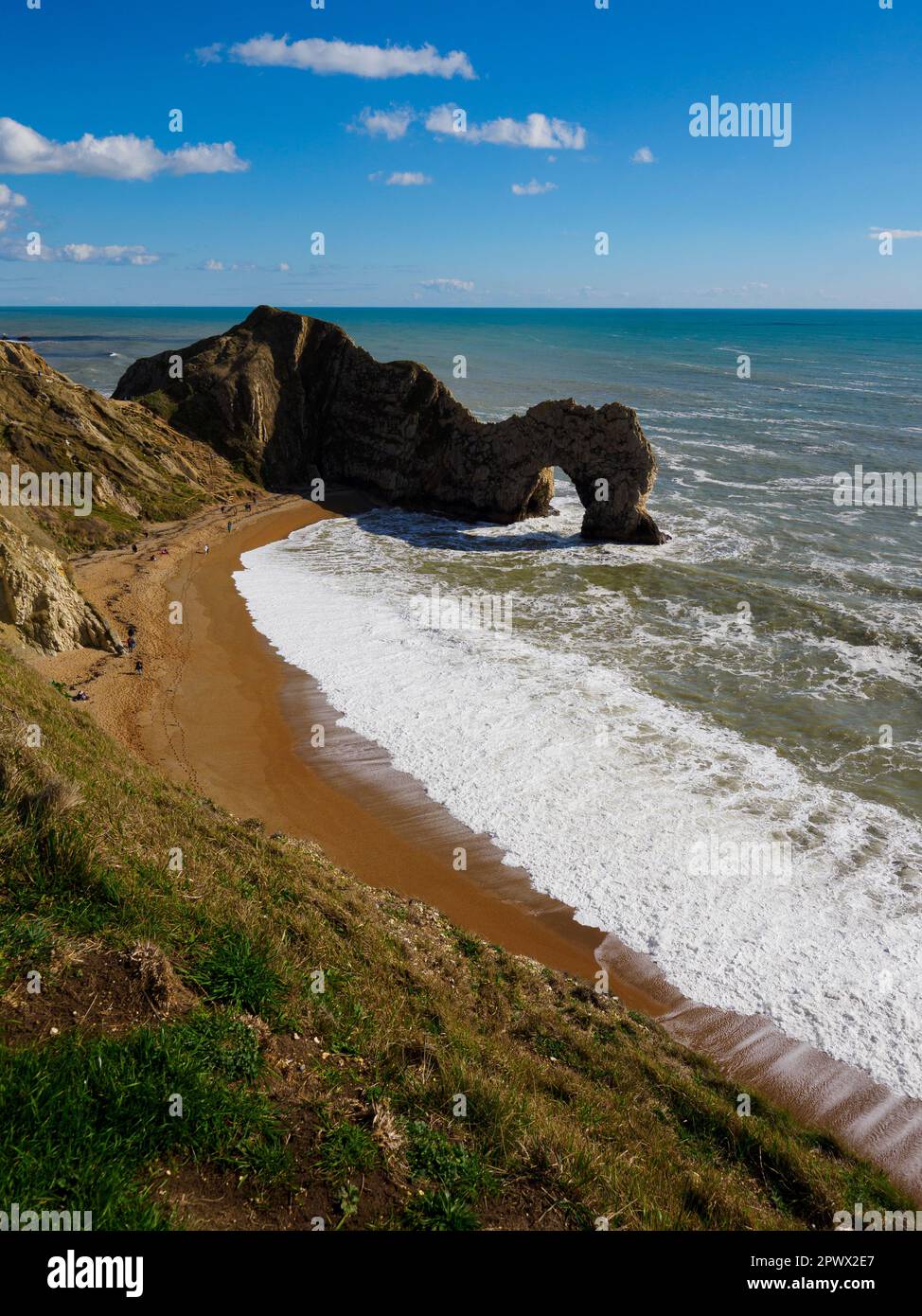 Durdle door and beach on a sunny day in March, Dorset, UK Stock Photo