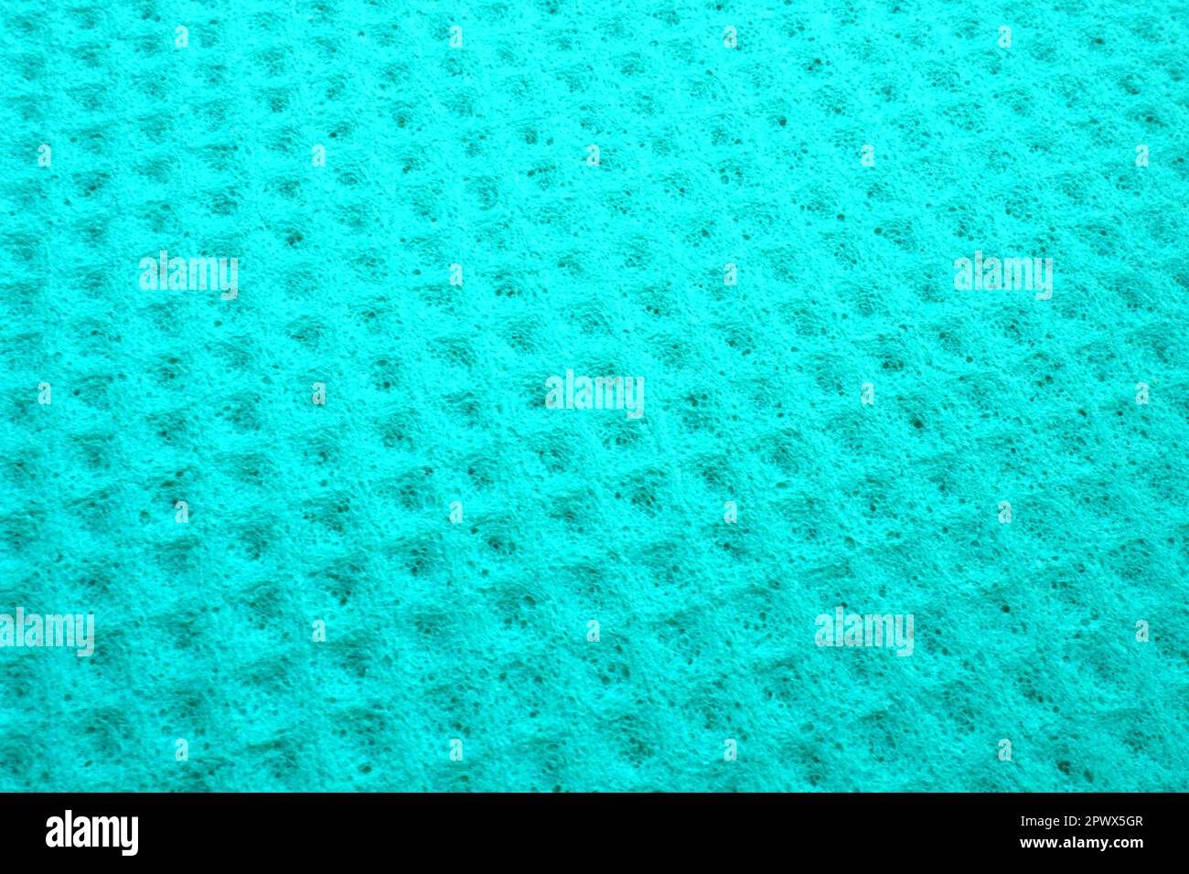 Sponge fibers sponge texture pattern surface close-up green background. Stock Photo
