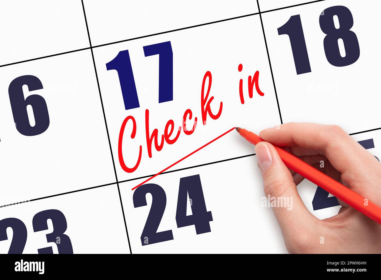 17th day of the month.  Hand writing CHECK IN and drawing a line on calendar date. Business.  Day of the year concept. Stock Photo
