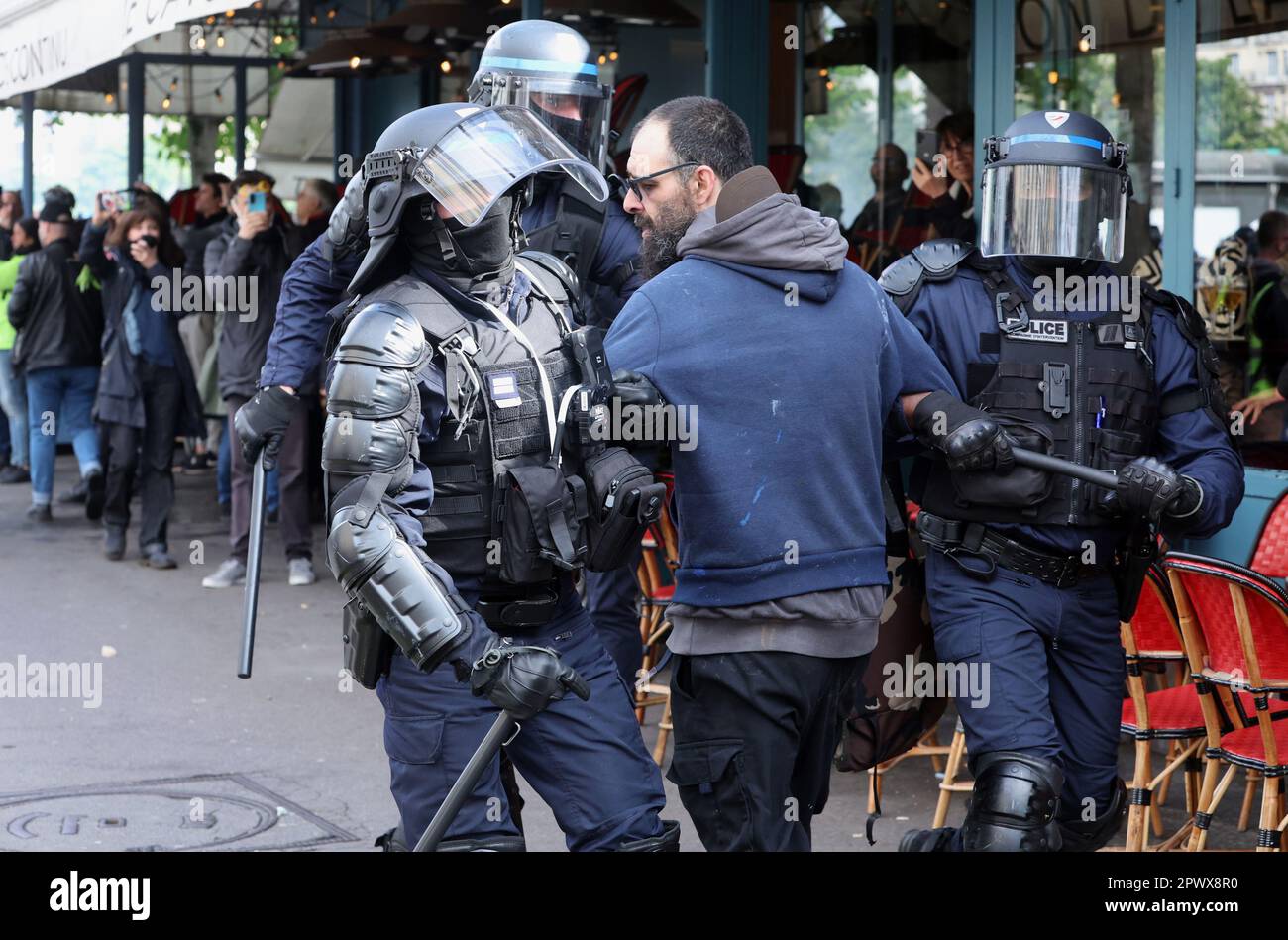 Paris, France. 01st May, 2023. Police arrest a protestor as violence erupted during a Labor Day mass protest in the streets of Paris, on Monday, May 1, 2023. Clashes erupted between security forces and radical protesters smashing bank windows as unions pushed the president to scrap a higher retirement age. Photo by Maya Vidon-White/UPI Credit: UPI/Alamy Live News Stock Photo