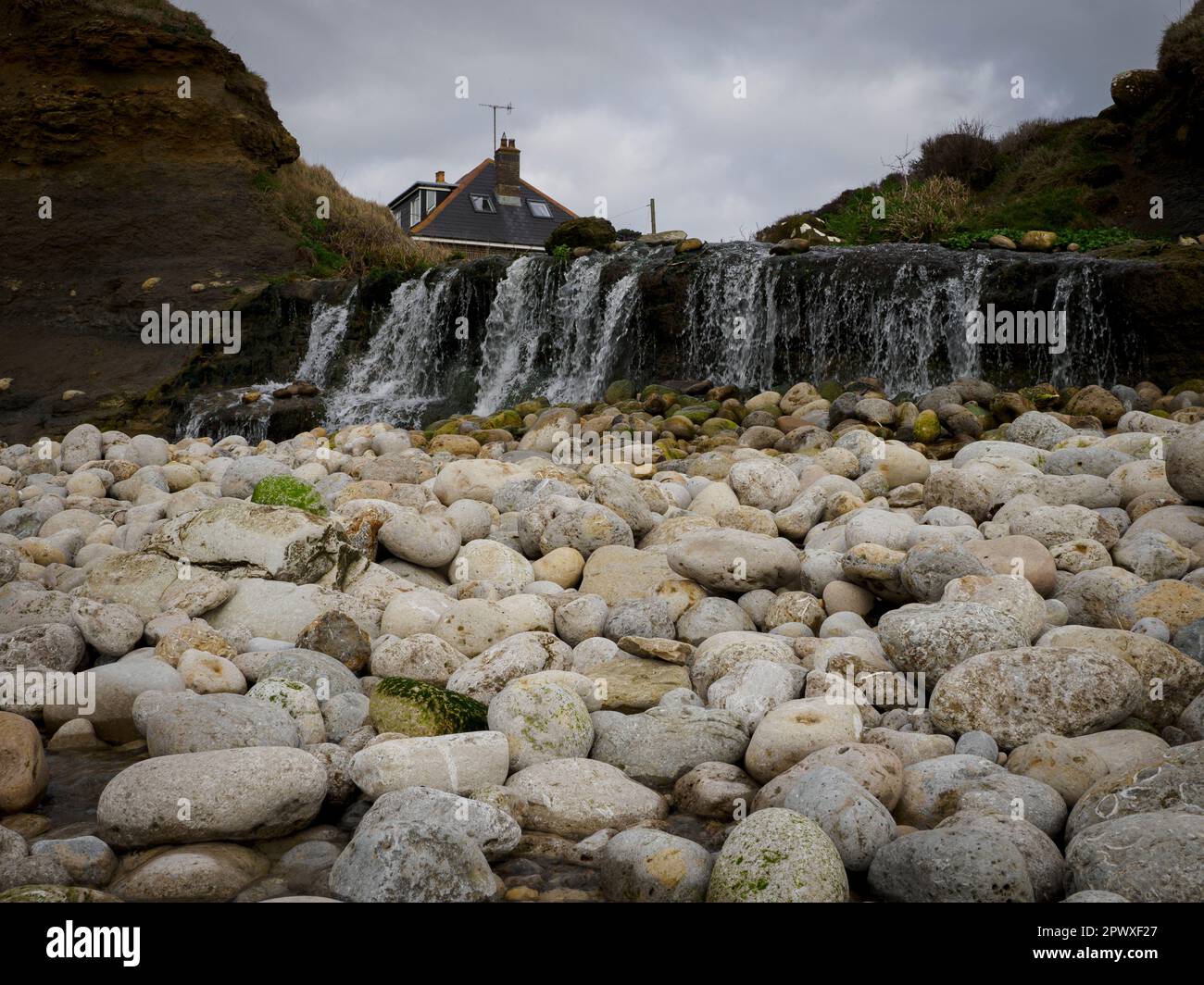 Waterfall at Osmington Mills beach, Dorset, UK Stock Photo Alamy