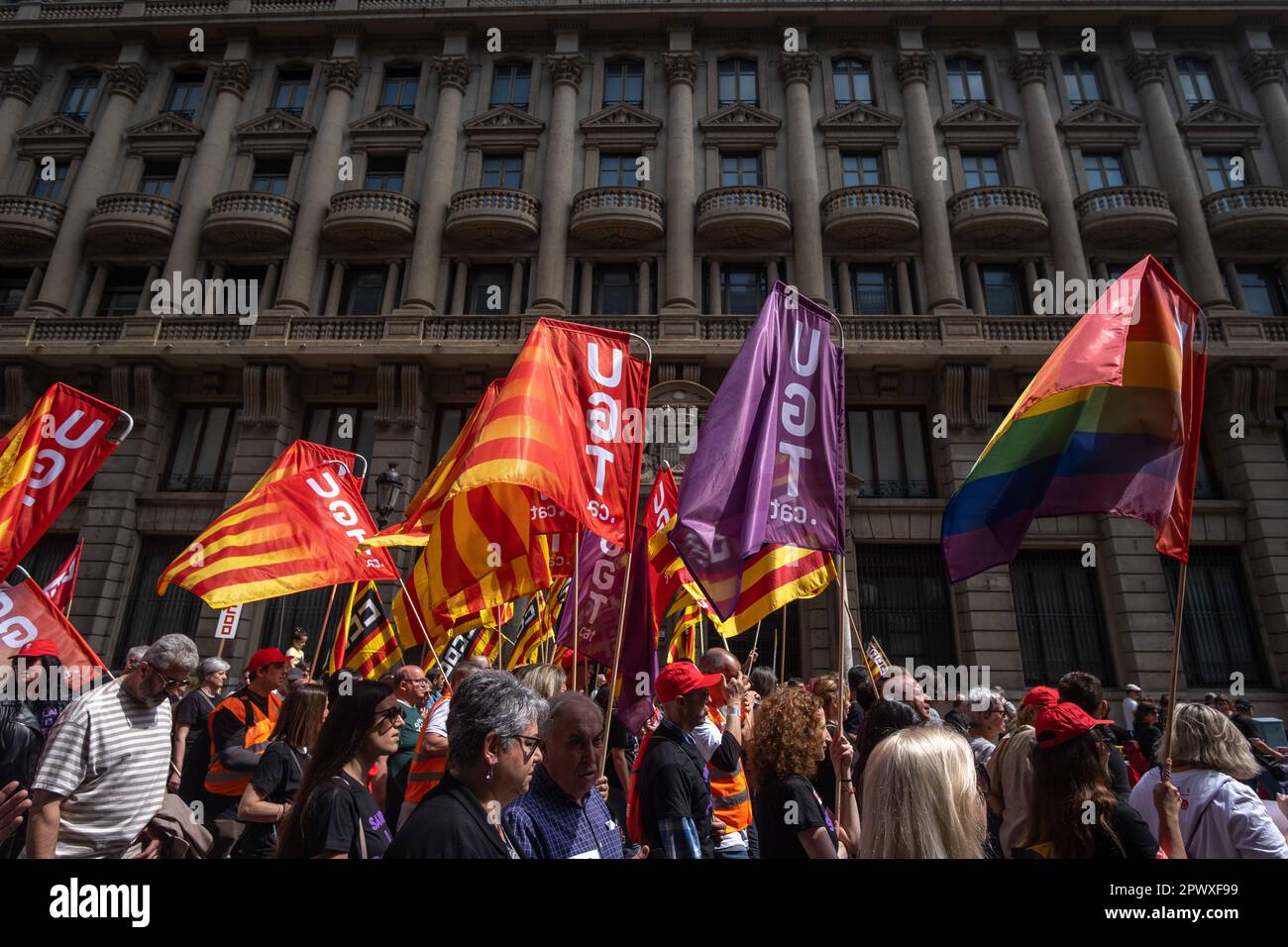 Barcelona, Spain. 01st May, 2023. Protesters hold Union flags as they march through VÌa Laietana during the demonstration. Thousands of people have demonstrated in the center of Barcelona called by the majority unions UGT and CCOO to celebrate International Workers' Day. (Photo by Paco Freire/SOPA Images/Sipa USA) Credit: Sipa USA/Alamy Live News Stock Photo