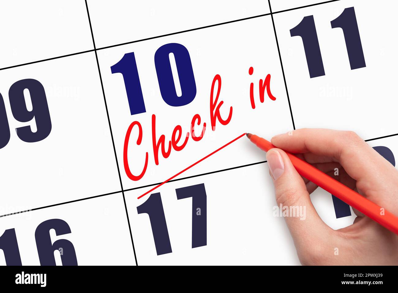 10th day of the month.  Hand writing CHECK IN and drawing a line on calendar date. Business.  Day of the year concept. Stock Photo
