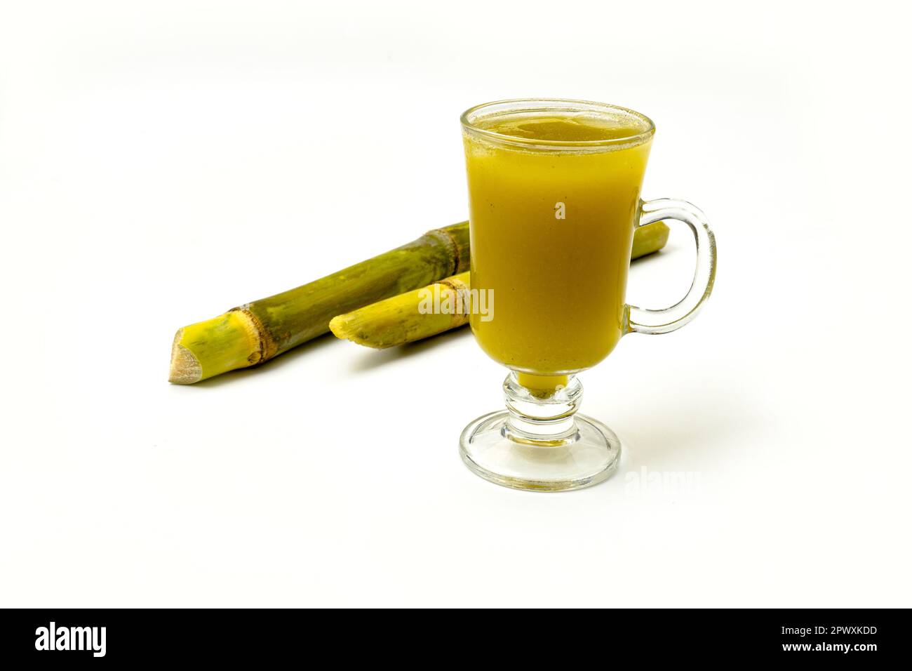 Fresh squeezed sugar cane juice with fresh cane sliced isolated on