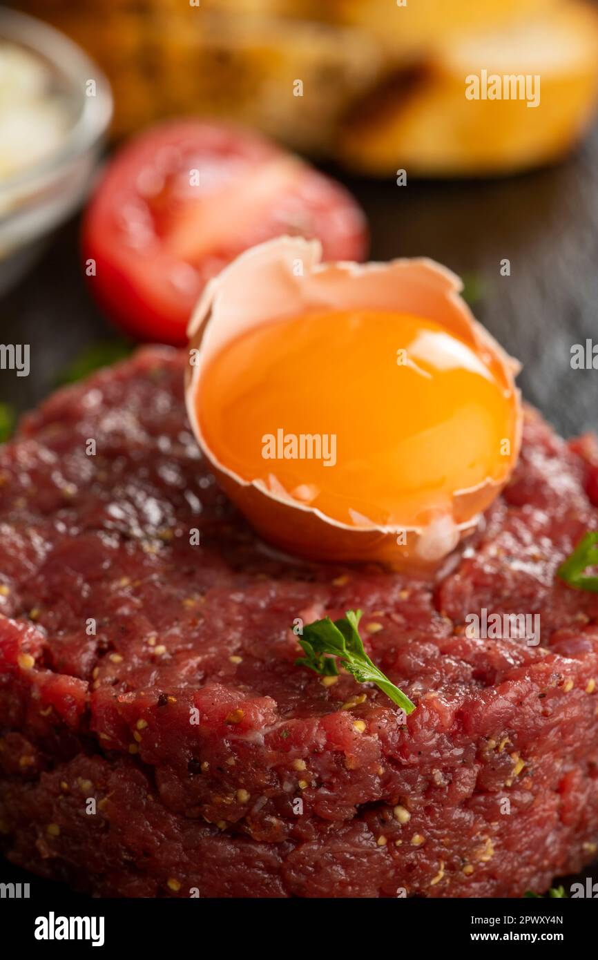 steak tartare on black slate Stock Photo Alamy