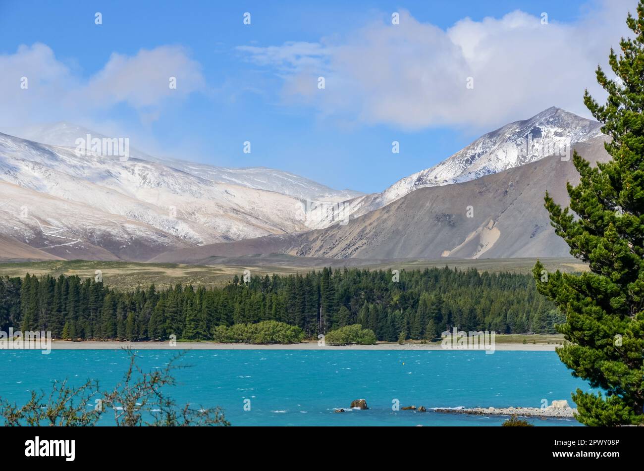Lake Tekapo is framed by Snow-Capped Mountain Peaks in New Zealand Stock Photo