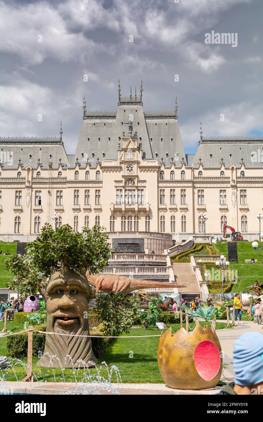 Iasi, Romania - April 28, 2023: Fairy tree and Dinosaurus in the park in the Palas Public Garden. Palatul Culturii or The Palace of Culture on backgro Stock Photo
