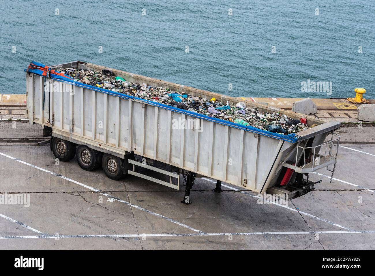 Overview of a container with glass bottles for recycling in the port of Barcelona, Catalonia, Spain Stock Photo