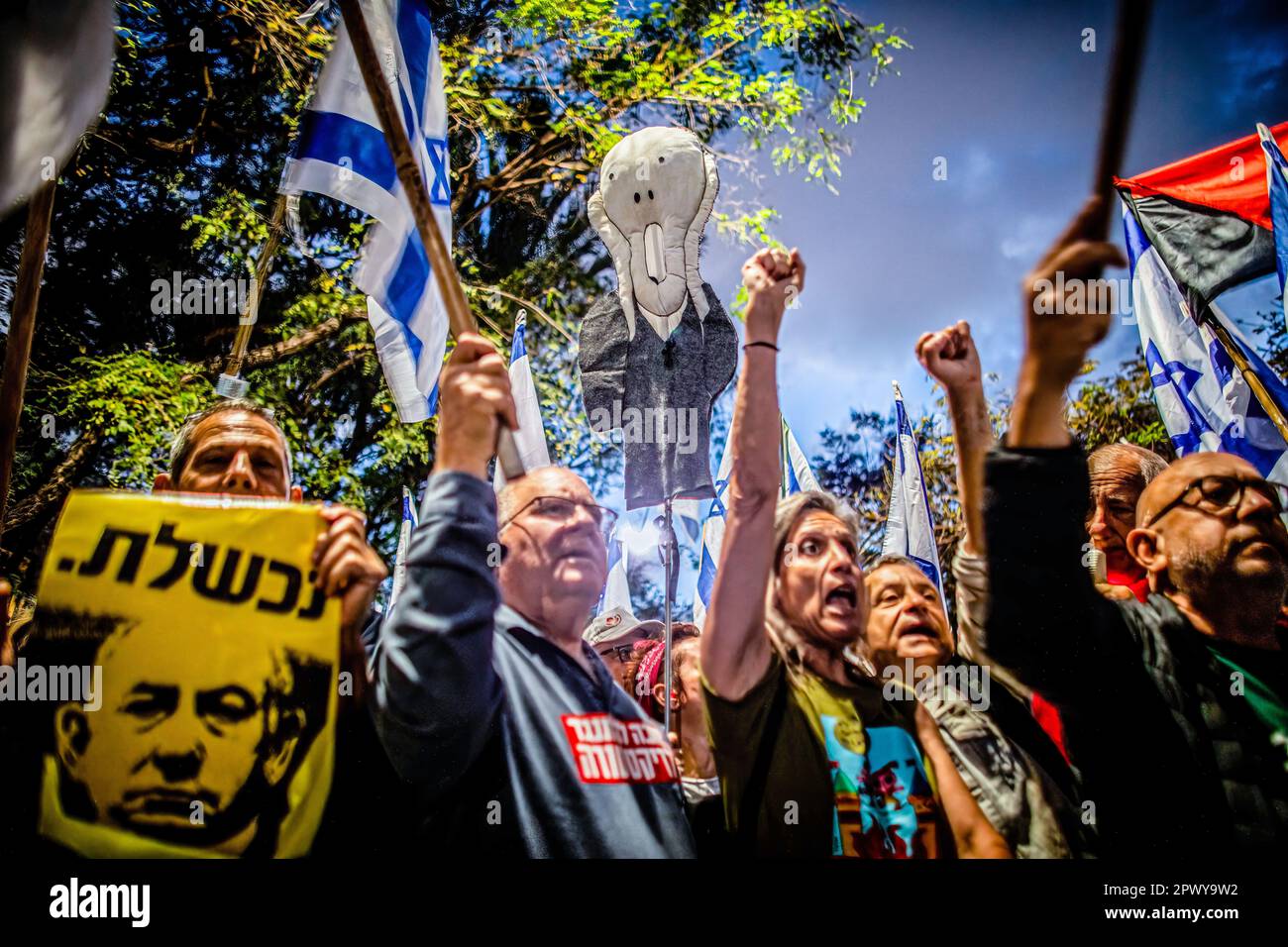 Tel Aviv, Israel. 30th Apr, 2023. Protestors wave the Israeli flag and hold placards that read in Hebrew: 'failed' with a photo of Prime Minister Benjamin Netanyahu during a demonstration in support of former chief Justice Aharon Barak in Tel Aviv. Hundreds of pro and anti-judicial reform protesters gathered outside the home of former High Court Justice president Aharon Barak on Sunday, after anti-reform groups expressed concern for his safety earlier in the day. Credit: SOPA Images Limited/Alamy Live News Stock Photo