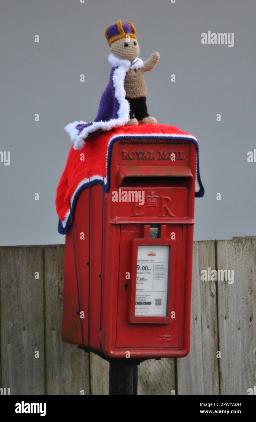 A coronation themed crocheted post box topper celebrating the