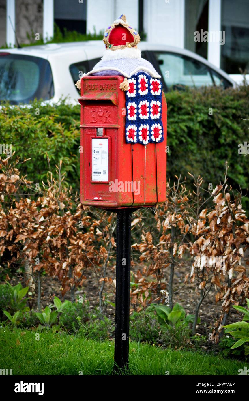 A coronation themed crocheted post box topper celebrating the