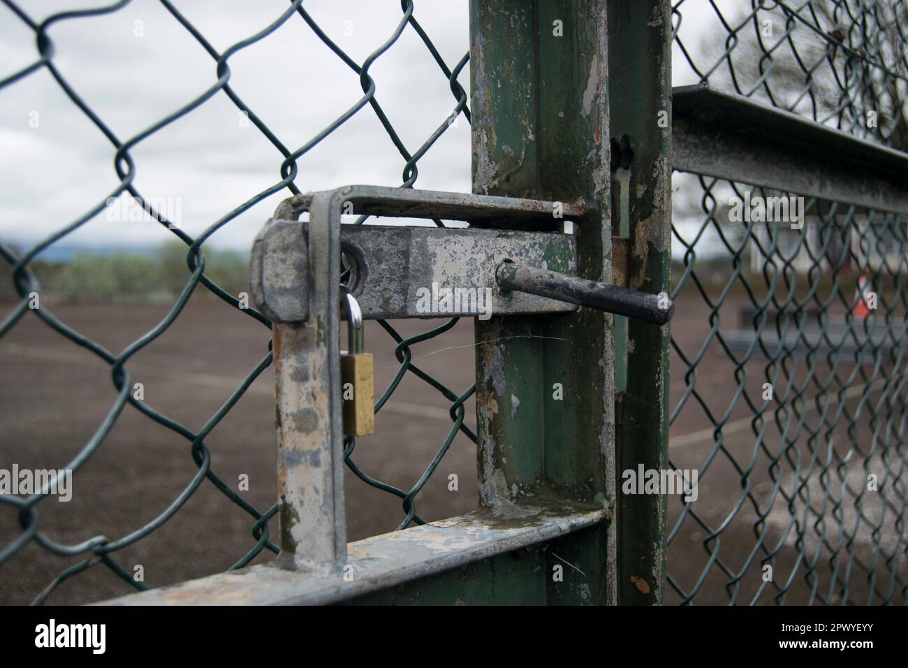 Padlocked gate of some tennis courts Stock Photo