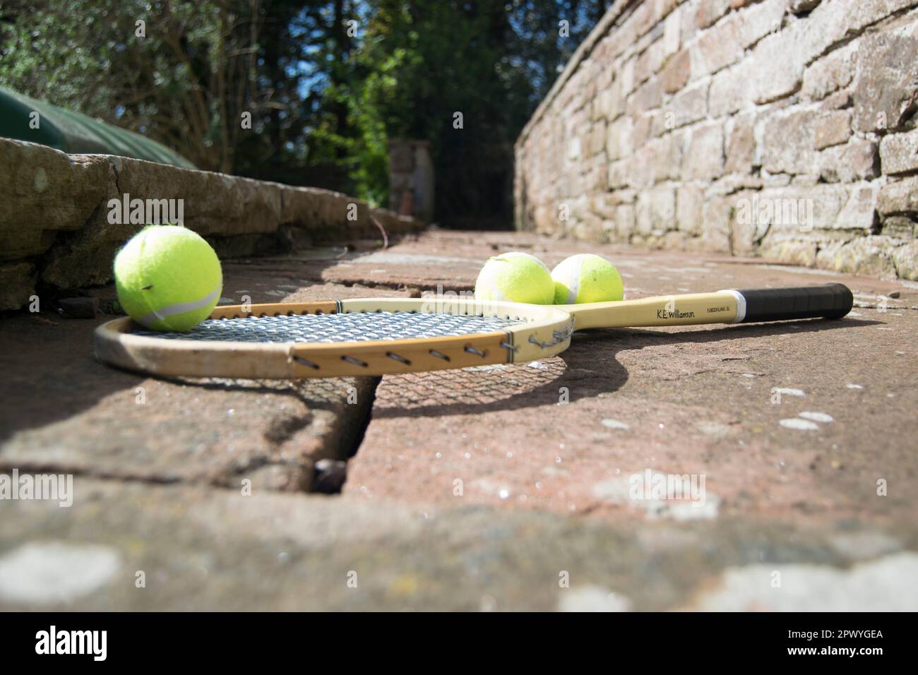 Tennis Racket Path Three tennis balls and vintage racket on the path Stock Photo - Alamy