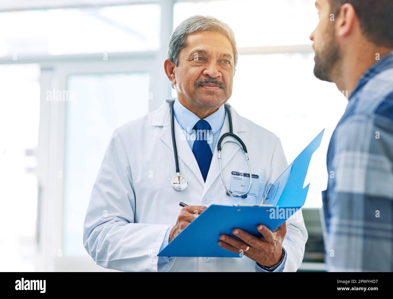 We are making progress. a confident mature male doctor running tests on a patient inside of a