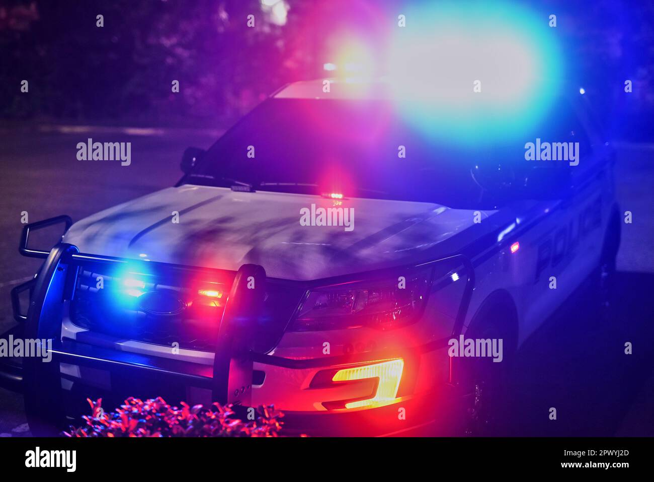 Making their presence felt. a police squad car outside at night Stock